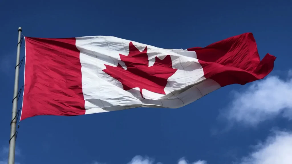 Canadian flag against a blue sky