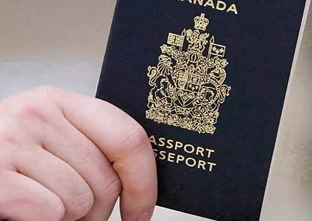 Hand holding a Canadian passport